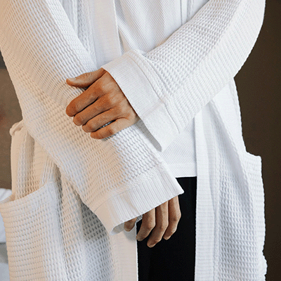 A white waffle bathrobe for hotel rooms and hospitality business.